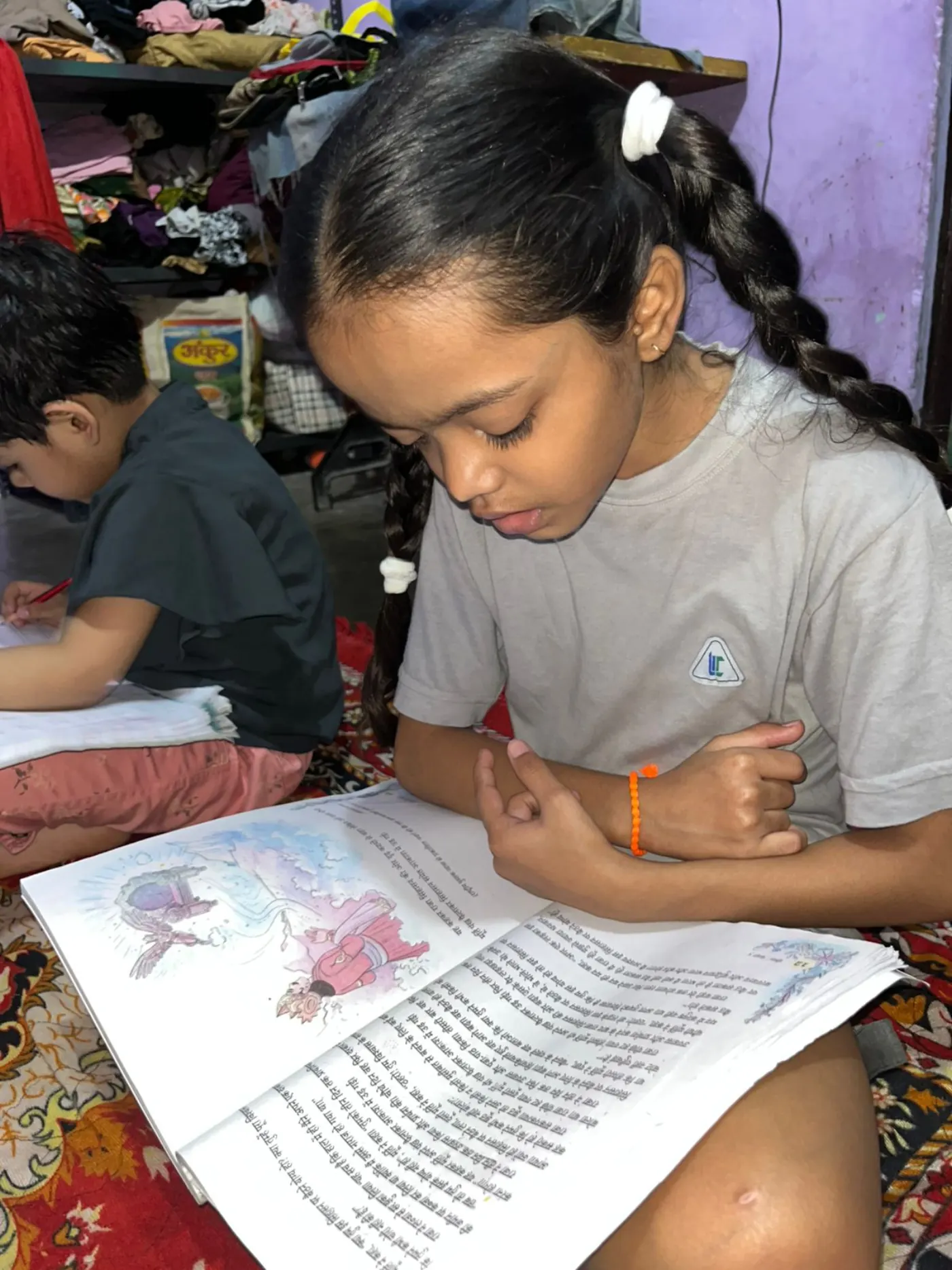 Two sisters reading their storybook at home
